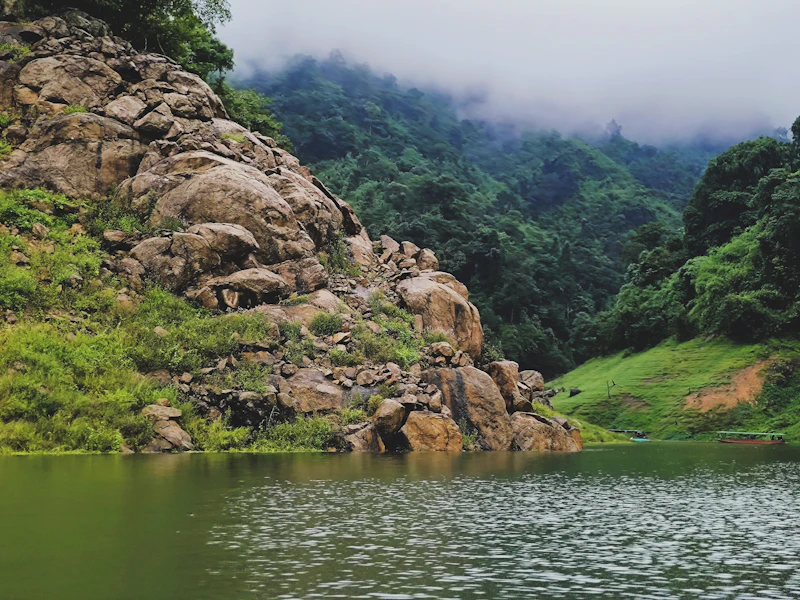 Green hills reflected in the water at Khun Dan Prakan Chon in Nakhon Nayok